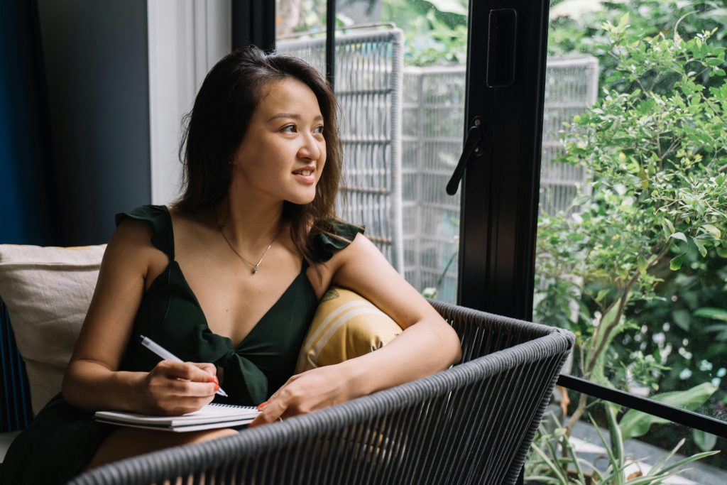 Woman journaling to manage emotional flashbacks and trauma response.