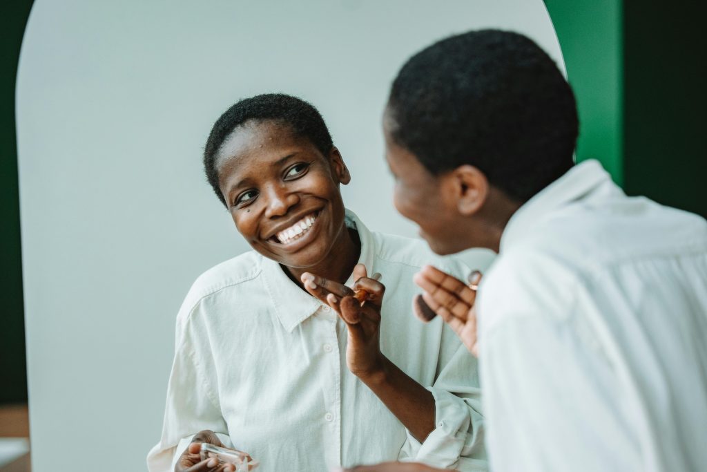 Two individuals share a joyful, reflective moment, with one person smiling broadly as they engage in a positive and uplifting conversation, highlighting moments that can boost self-esteem.