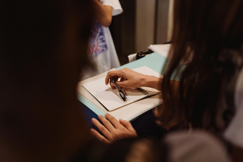 Close-up of someone writing in a trauma and addressing learning disabilities.