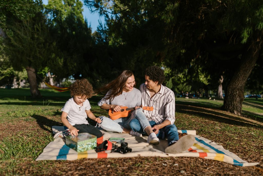 Family bonding outdoors with ukulele