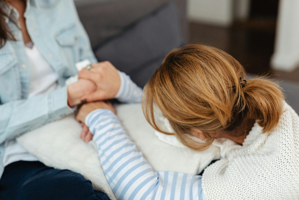 Woman comforting a distressed girl, symbolising support for inattentive adhd.