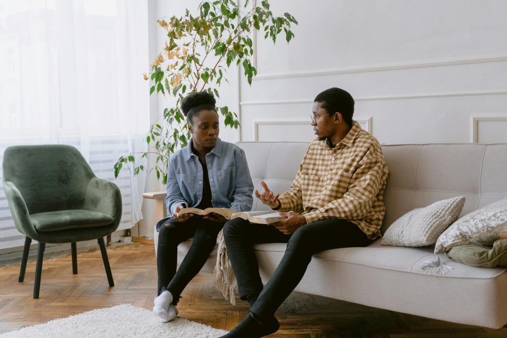 Black couple in therapy discussing emotional disconnection and relationship challenges.