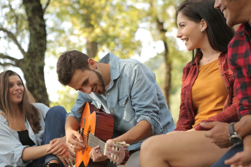 Group of friends outdoors enjoying music as prevention and early mental health support