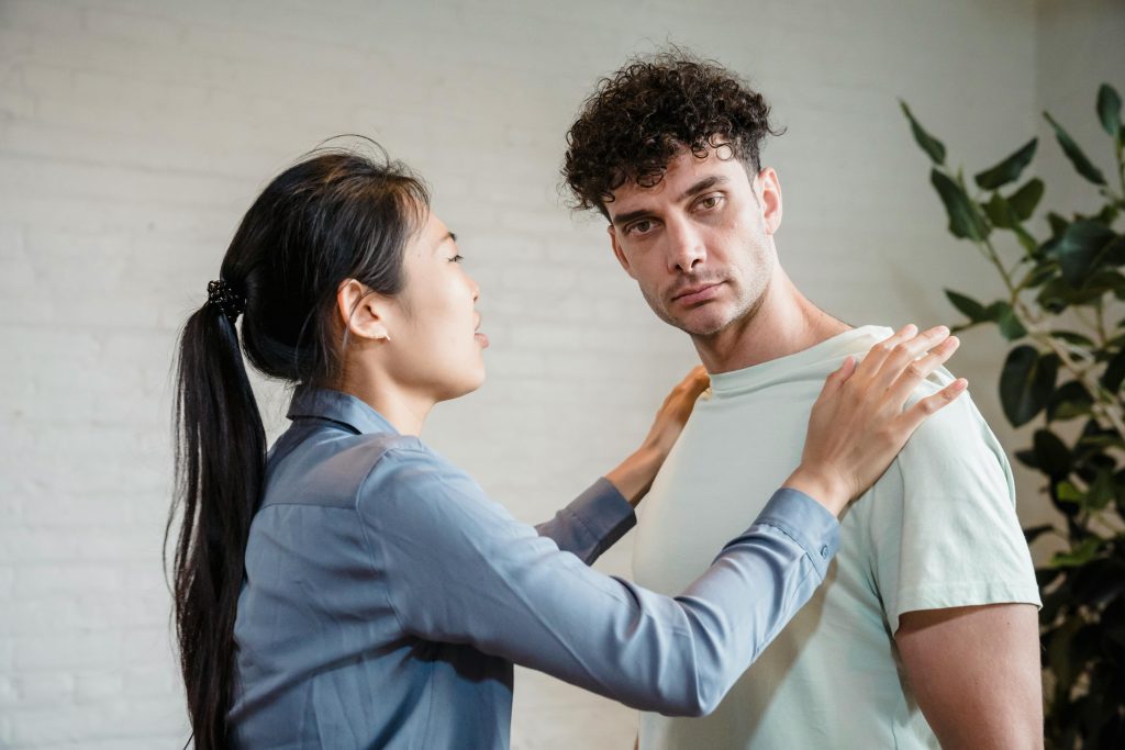 Woman confronts man during emotional tension indoors.