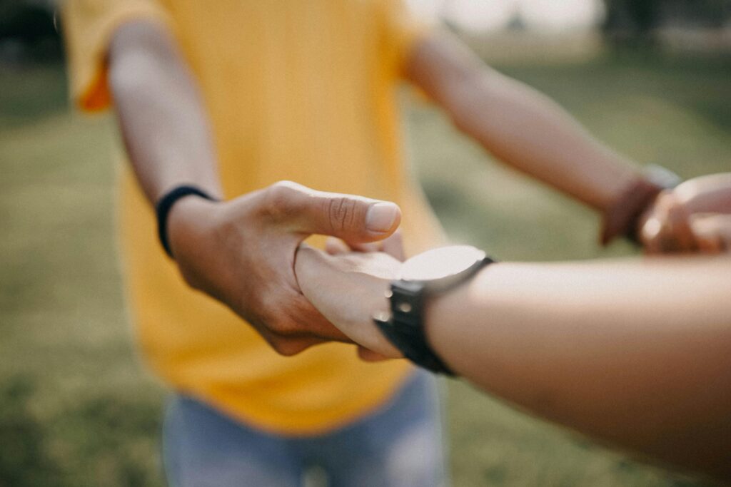 Two people holding hands while discussing why do i cancel plans at the last minute feelings