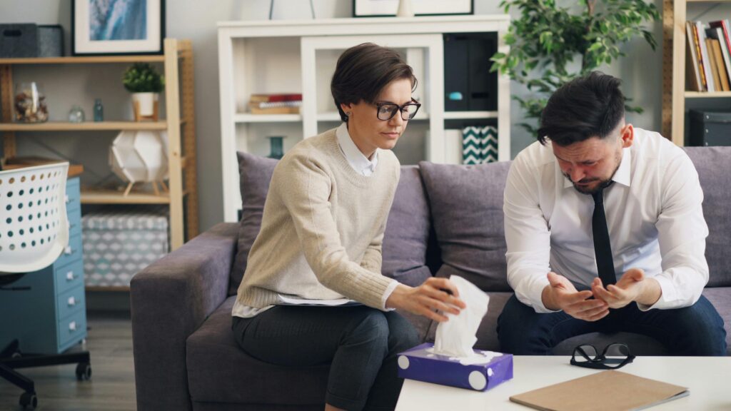 Therapist supporting a distressed man during a why do i cry a lot counselling session
